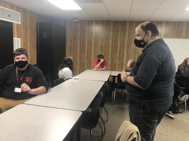 Joseph Holmberg (right) communicates with a student during an activity to practice sign language descriptors.
