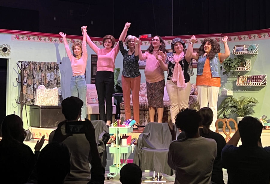 The all-girl cast holds hands to take a bow after the final act.