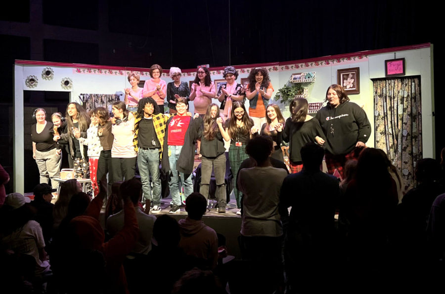 Cast and crew stand together at the end of the production.