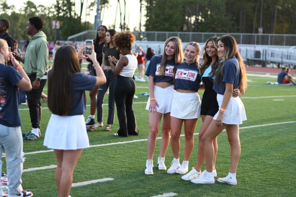 Senior Ashley Alfaro snaps a picture of seniors Taylor McIntyre, Ava Phillips, Abigail Martinez and Gabriella Lilley. The girls are all on the cheer team and decided to coordinate matching outfits for the event. All have been on the same cheer squad since freshman year. 

