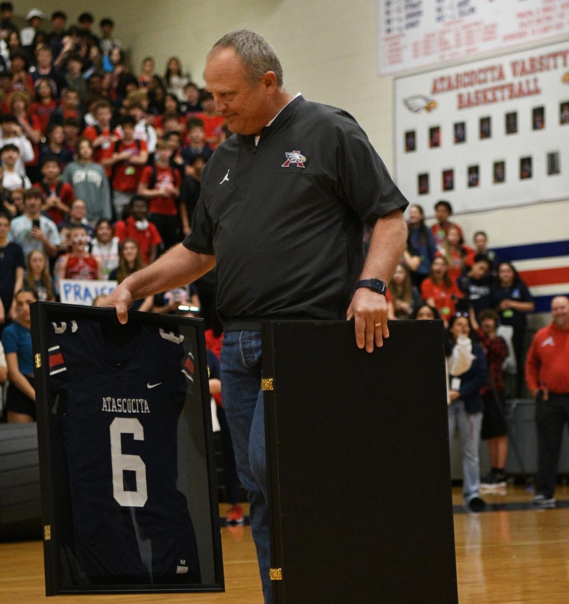 Coach Stump brings the jerseys to Cosmi and Taylor.