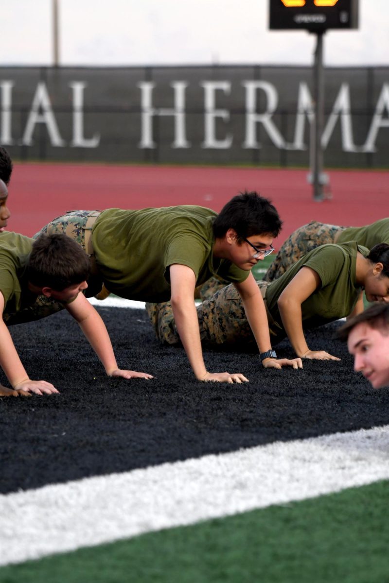 Sophomore Allen Gomez does push-ups after the football team scores a touchdown at Turner Stadium.