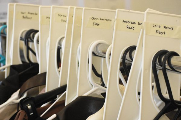 Hung up costumes created by the production crew await the “Newsies” musical. (Photo by senior Sarene AndriusWalker)
