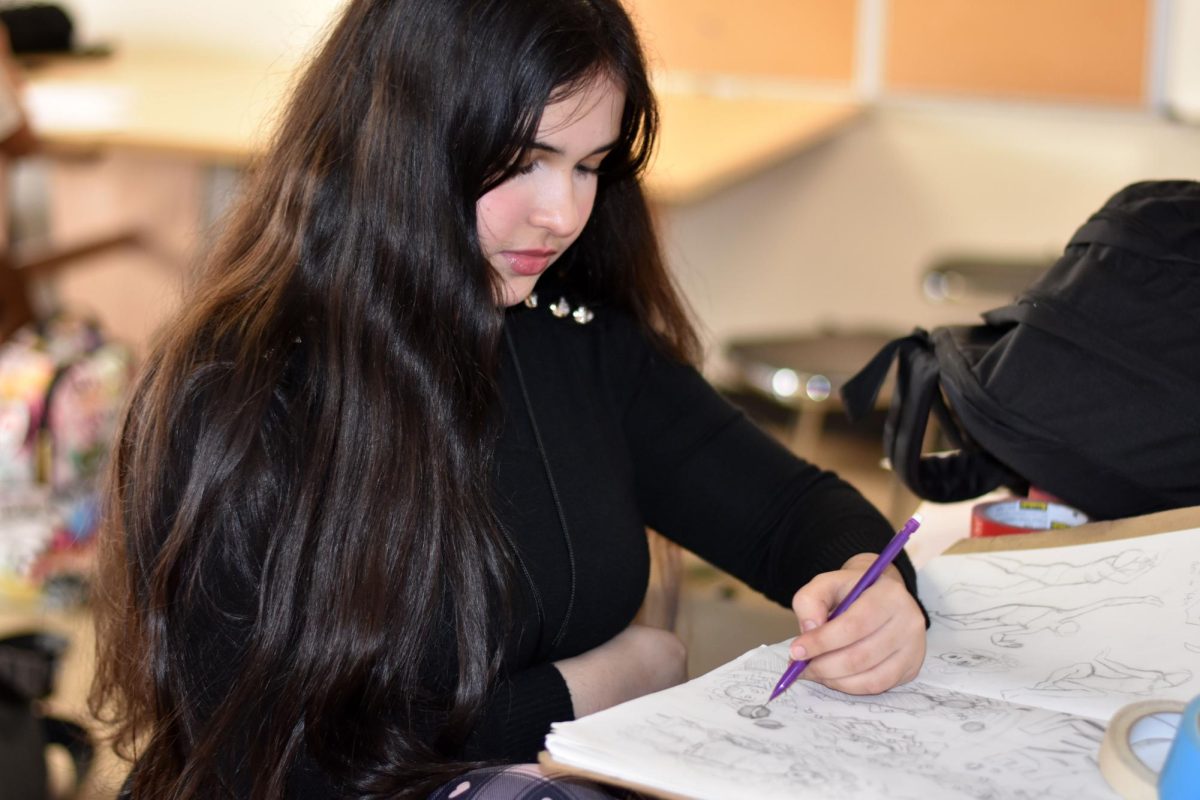 Freshman Haya Ahmed draws in her sketch book, Ahmed is in Art I. (Photo by sophomore Nyla Powell)