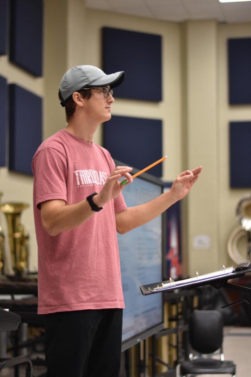 Band Director Alexei Wade directs the symphonic band during third period.