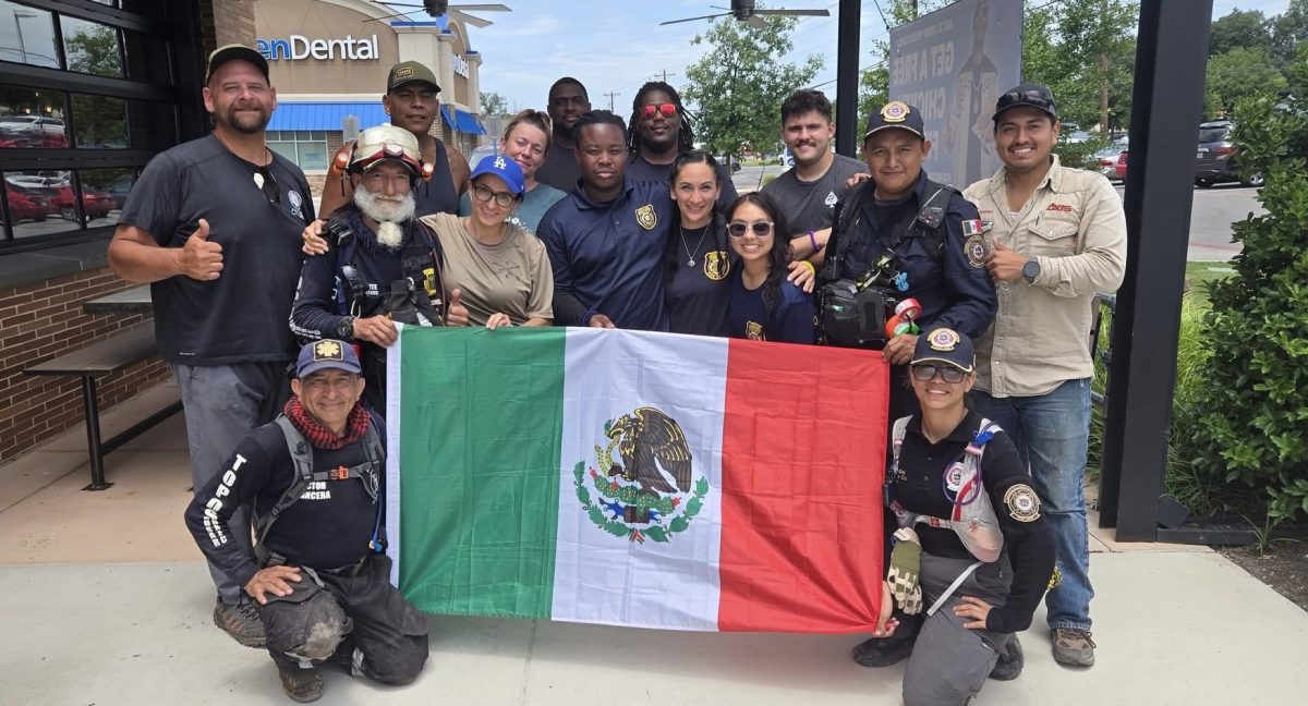 Aerospace/UAV Teacher Harvey Paneitz gathers with volunteers and first responders. Paneitz worked with divers, police officers, firefighters and community volunteers.